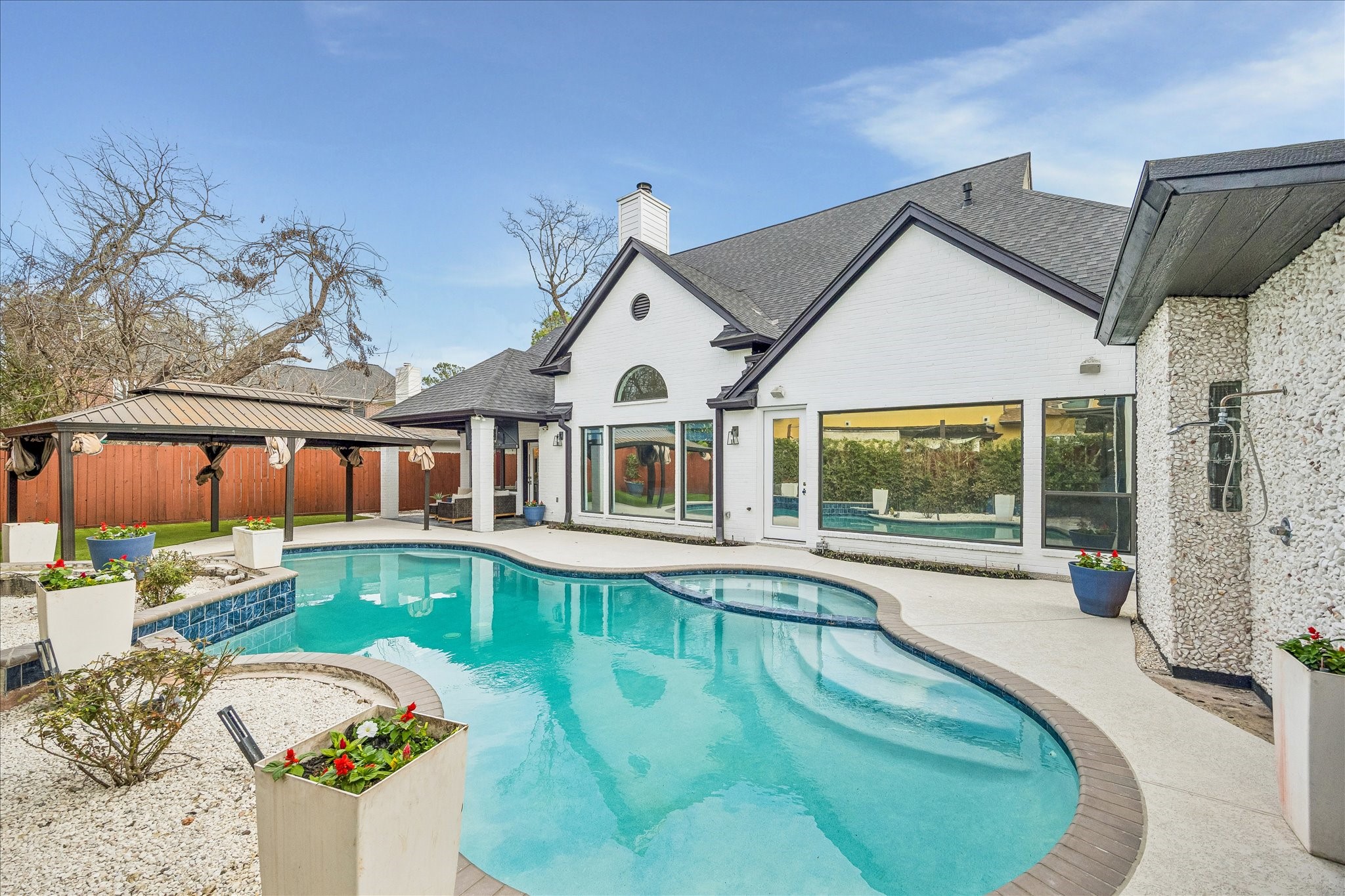 4614 Spruce Street Bellaire, TX 77401 - Photo 4 of 30 a view of a house with swimming pool and porch