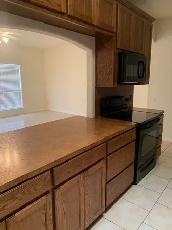 a kitchen with granite countertop cabinets and steel appliances