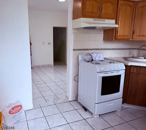 a stove top oven sitting inside of a kitchen