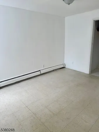 a view of a refrigerator in an empty room
