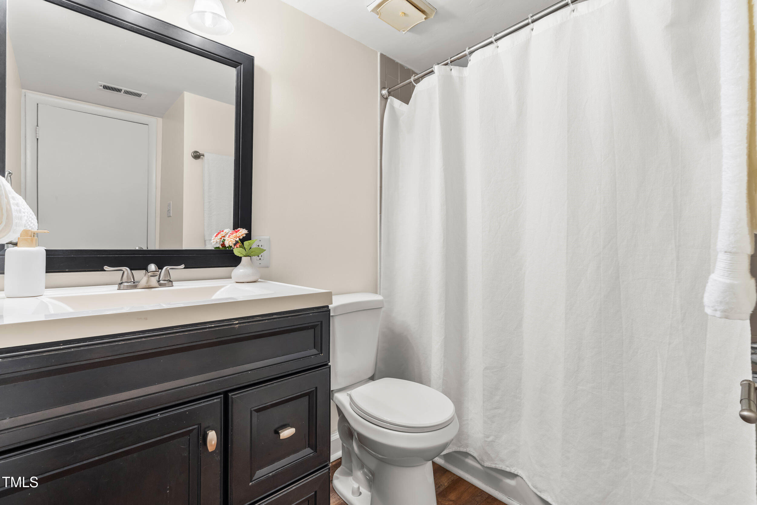 1212 Schaub Drive, Unit C Raleigh, NC 27606 - Photo 18 of 23 a bathroom with a sink and a mirror