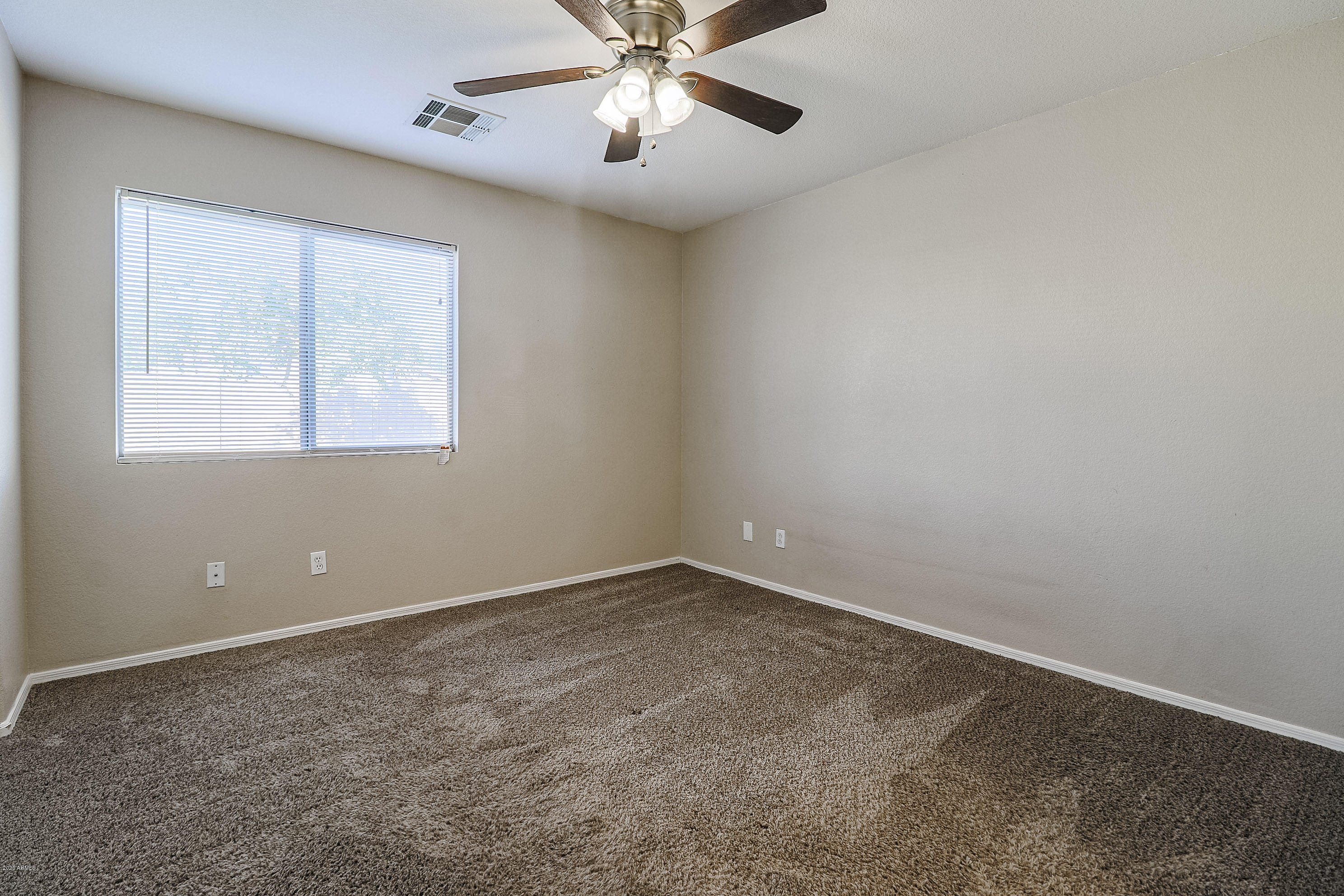 15038 West Redfield Road Surprise, AZ 85379 - Photo 11 of 21 an empty room with windows and fan