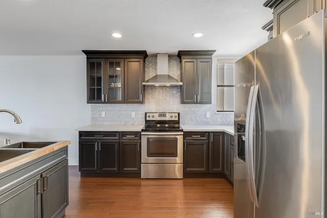 a kitchen that has a sink and a stove