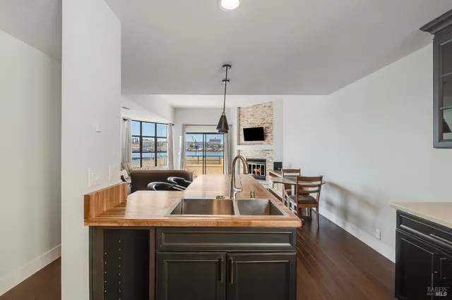 a room with kitchen island a sink cabinets and wooden floor