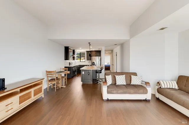 a kitchen with stainless steel appliances granite countertop a refrigerator a stove and a sink