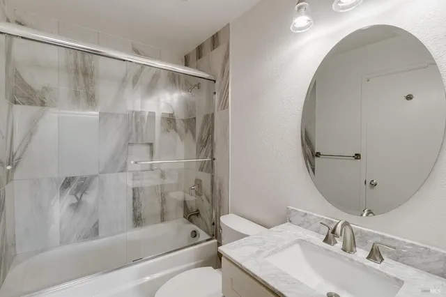 a en suite bathroom with a toilet sink and mirror