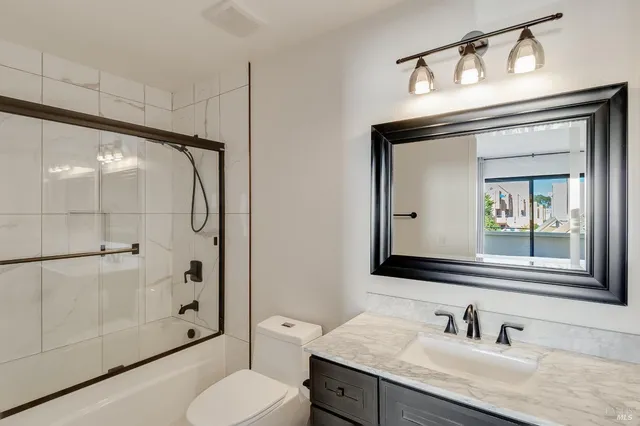 a view of multiple houses with a street