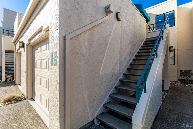 a balcony with table and chairs