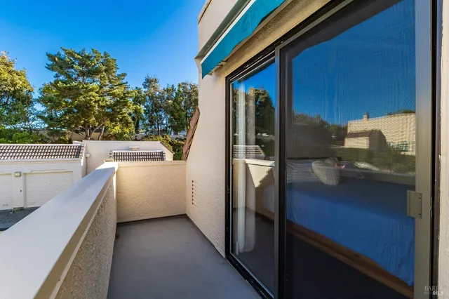 a view of a hallway with wooden floor and closet