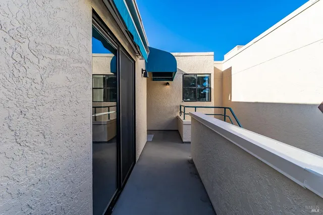 a en suite bathroom with a granite countertop sink and a mirror