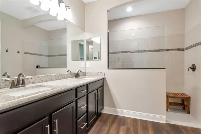 a bathroom with a double vanity sink and a mirror