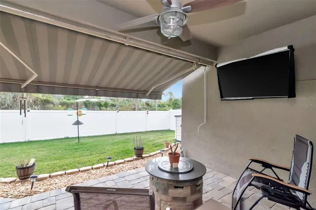a view of a patio with a table and chairs