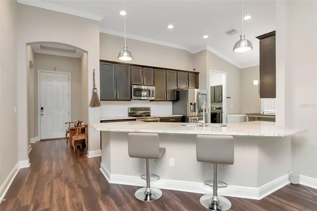 a kitchen with stainless steel appliances a sink stove and refrigerator