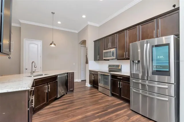 a kitchen with stainless steel appliances and wooden cabinets