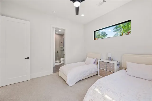 a bedroom with two beds and a chandelier