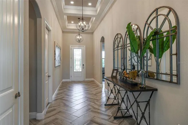 a dining room with furniture and chandelier