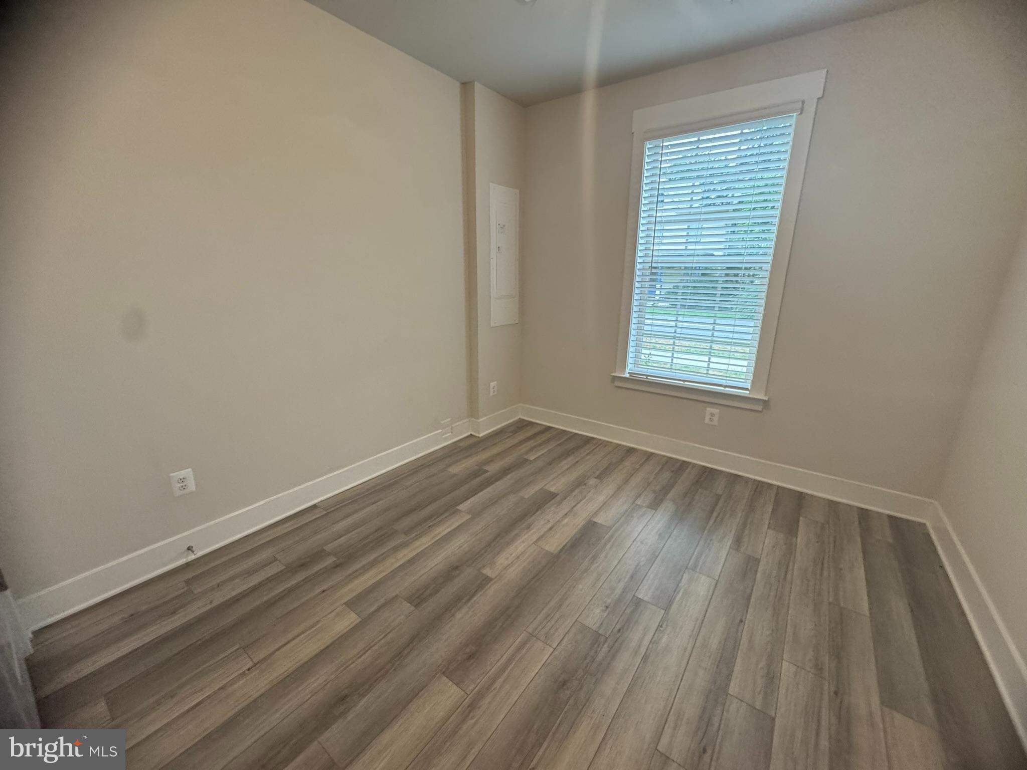7919 Wormans Mill Road Frederick, MD 21701 - Photo 5 of 23 an empty room with wooden floor and windows