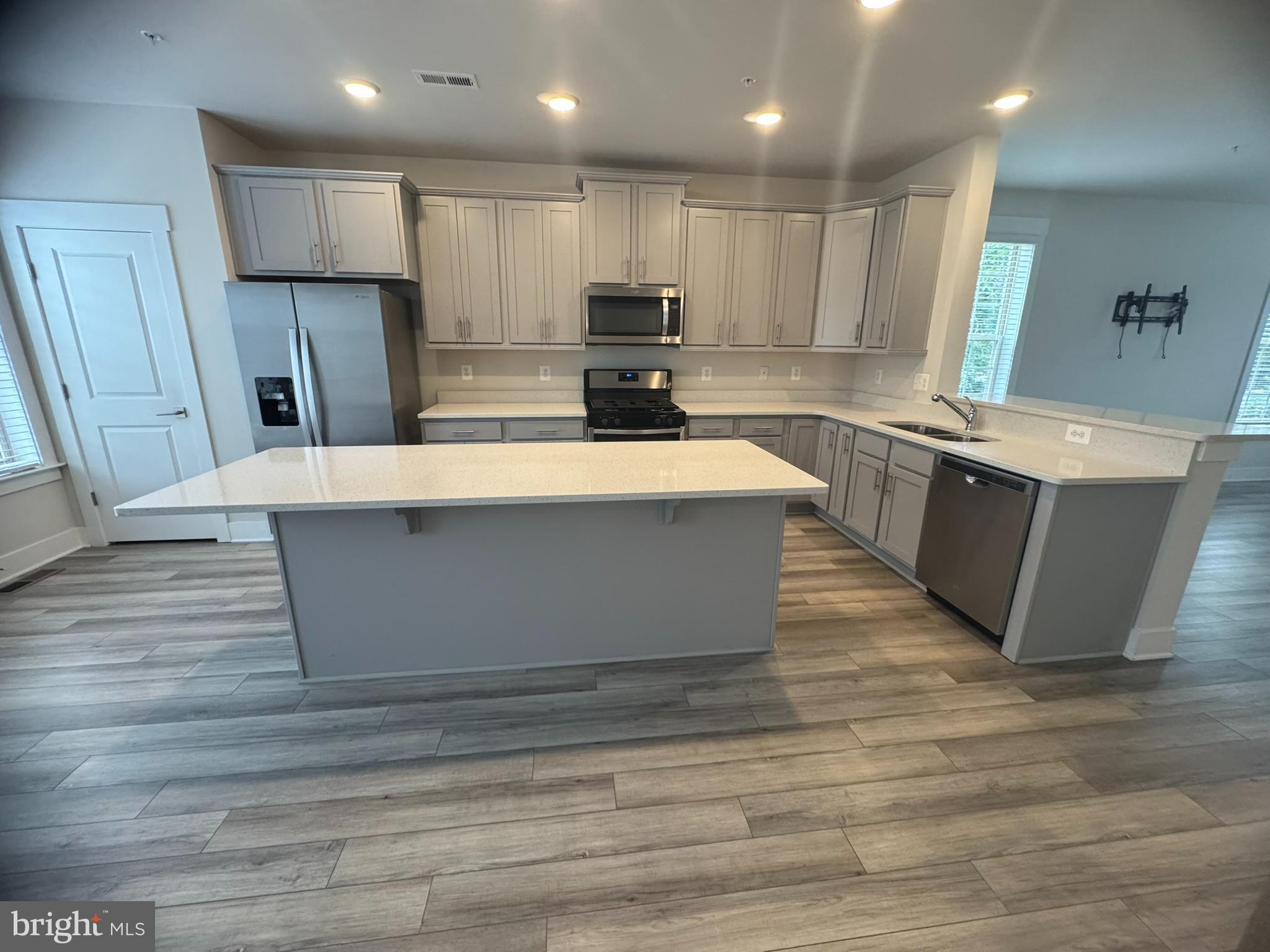 7919 Wormans Mill Road Frederick, MD 21701 - Photo 6 of 23 a large kitchen with stainless steel appliances granite countertop a stove a refrigerator a sink and a oven