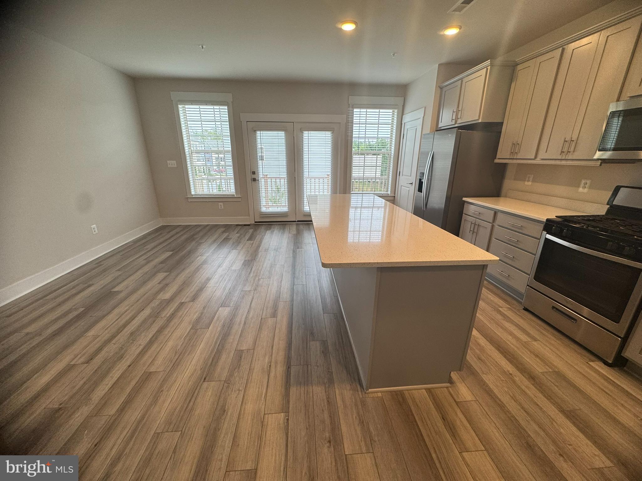 7919 Wormans Mill Road Frederick, MD 21701 - Photo 7 of 23 a room with wooden floors and glass windows