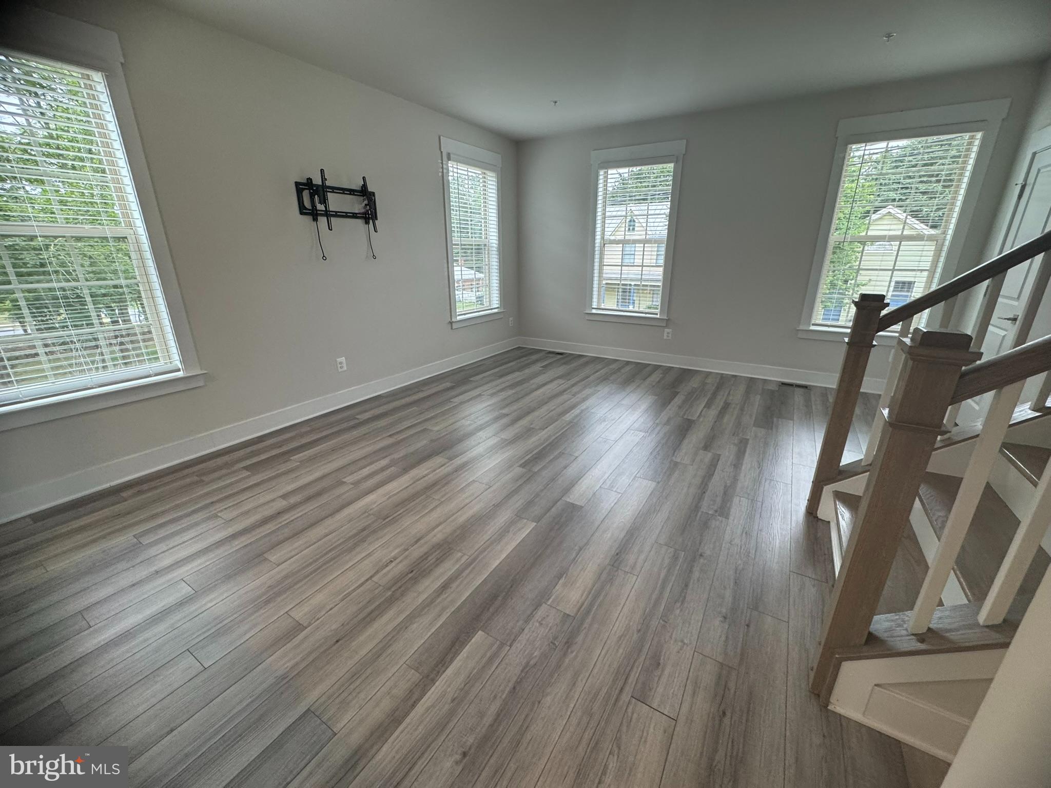7919 Wormans Mill Road Frederick, MD 21701 - Photo 9 of 23 a view of an empty room with wooden floor and a window