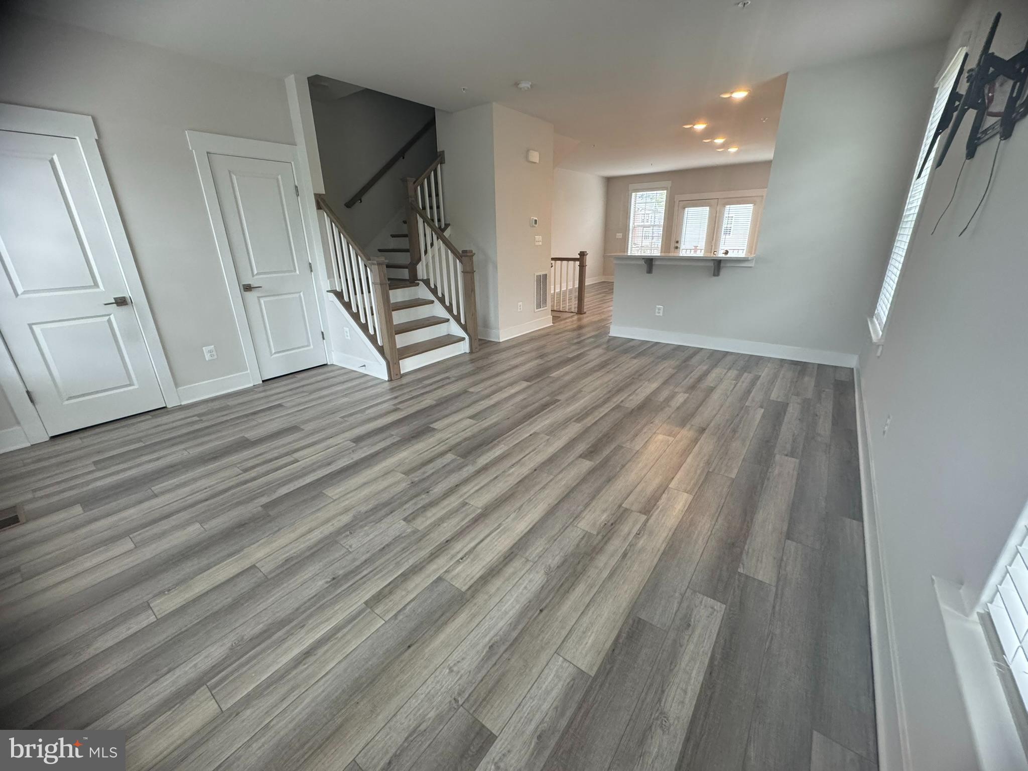 7919 Wormans Mill Road Frederick, MD 21701 - Photo 10 of 23 a view of an empty room with wooden floor and stairs