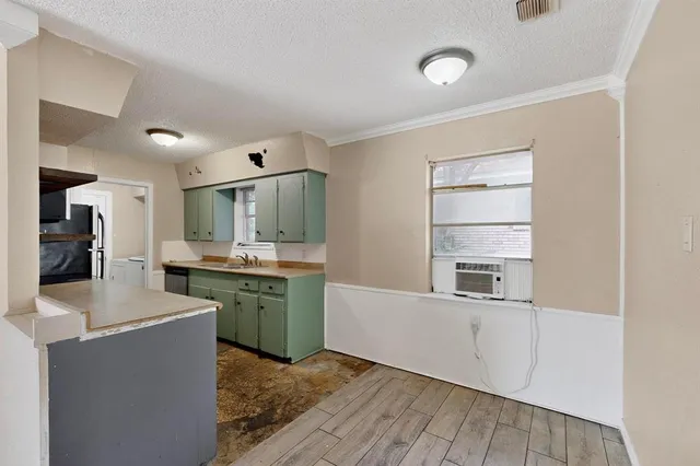 a kitchen with a refrigerator and a sink