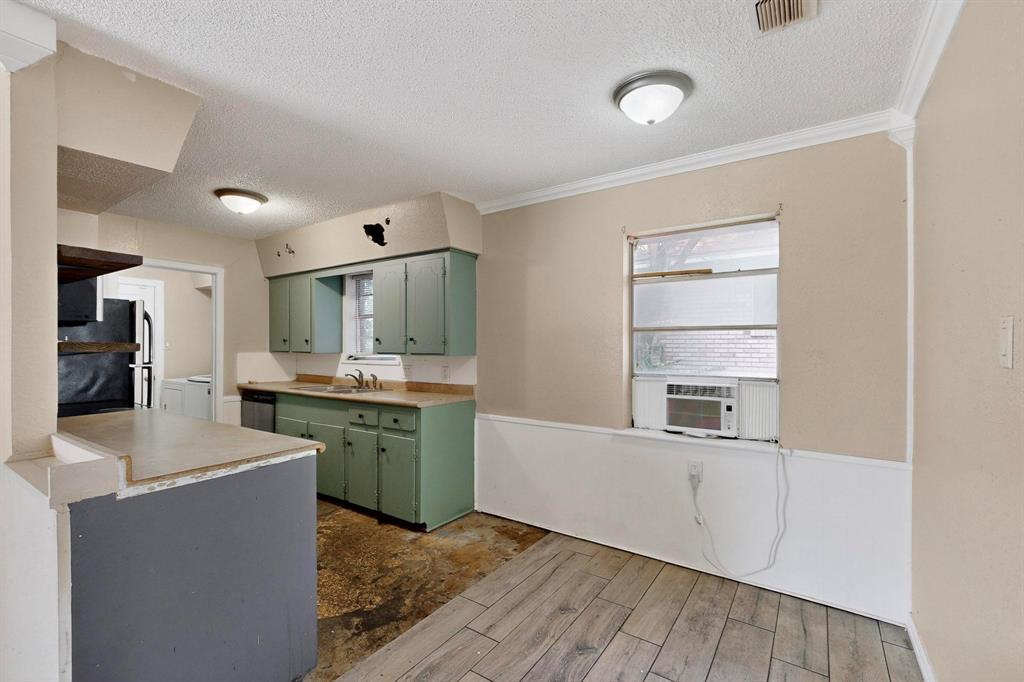 702 Rea Avenue Lancaster, TX 75146 - Photo 13 of 37 a kitchen with a refrigerator and a sink