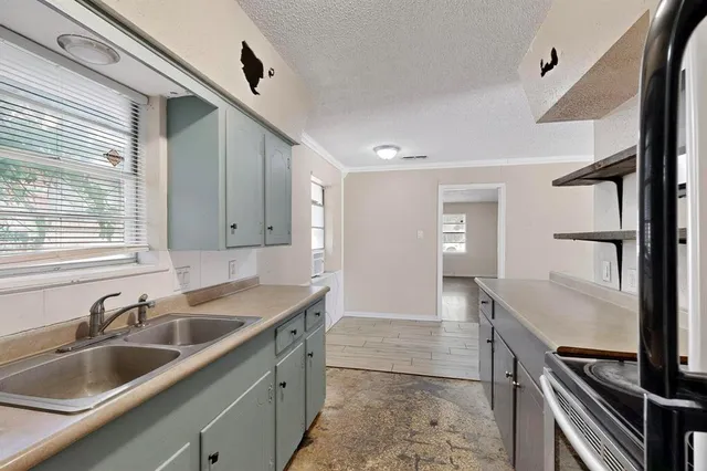 a kitchen with a sink and cabinets