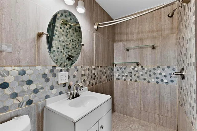 a bathroom with a sink toilet and shower