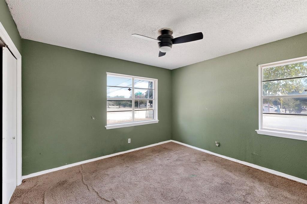 702 Rea Avenue Lancaster, TX 75146 - Photo 26 of 37 an empty room with a window and a ceiling fan