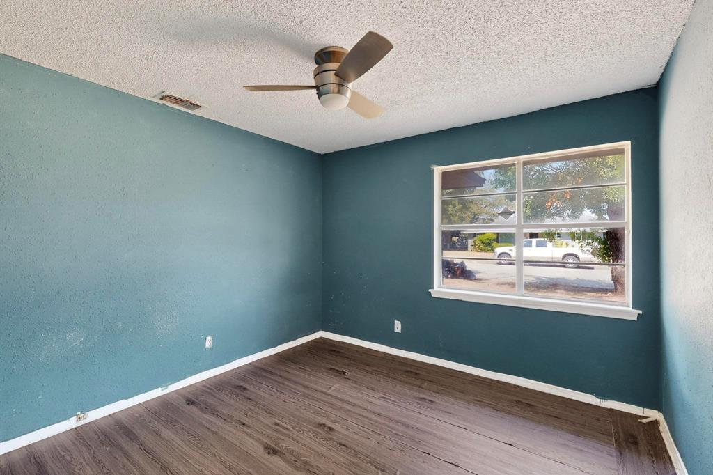 702 Rea Avenue Lancaster, TX 75146 - Photo 30 of 37 an empty room with wooden floor and windows