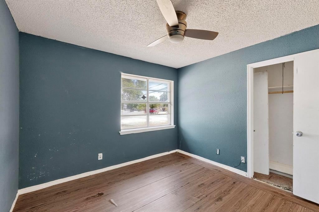 702 Rea Avenue Lancaster, TX 75146 - Photo 31 of 37 an empty room with wooden floor and windows
