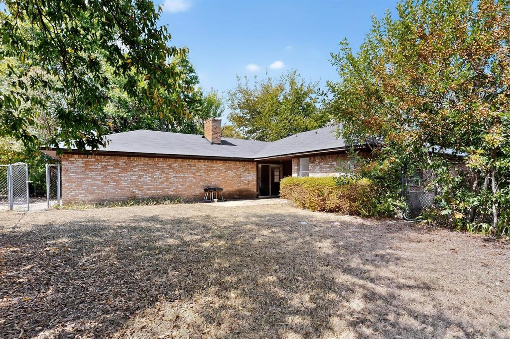 702 Rea Avenue Lancaster, TX 75146 - Photo 34 of 37 a front view of a house with a yard and trees