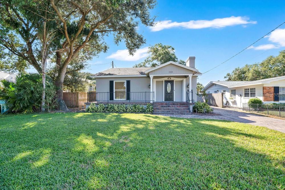 a front view of a house with a garden