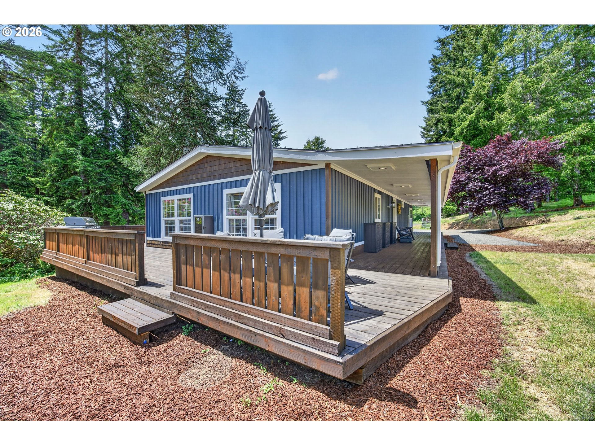6895 Canary Road Westlake, OR 97493 - Photo 28 of 40 a view of backyard with a deck and a garden