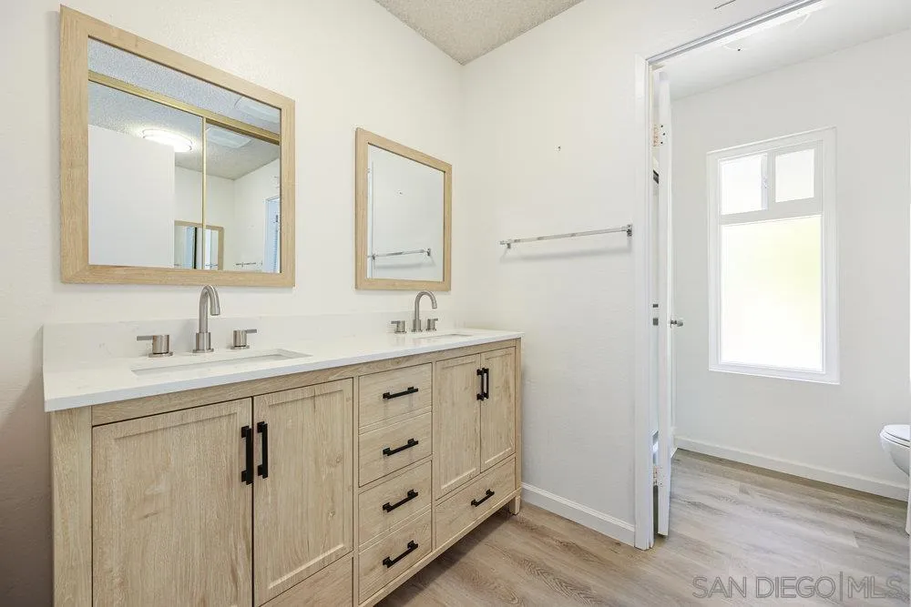 14545 Hillndale Way Poway, CA 92064 - Photo 18 of 27 a bathroom with double vanity sink a mirror and a shower