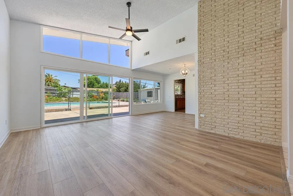 14545 Hillndale Way Poway, CA 92064 - Photo 6 of 27 a view of a livingroom with wooden floor a ceiling fan and window