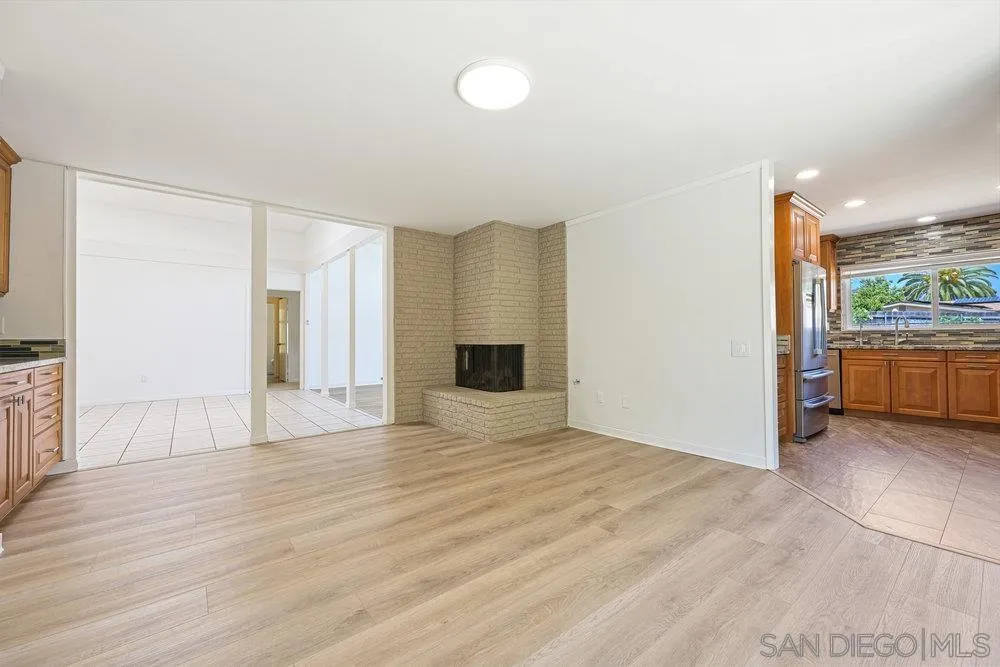 14545 Hillndale Way Poway, CA 92064 - Photo 7 of 27 a view of an empty room with wooden floor and a window