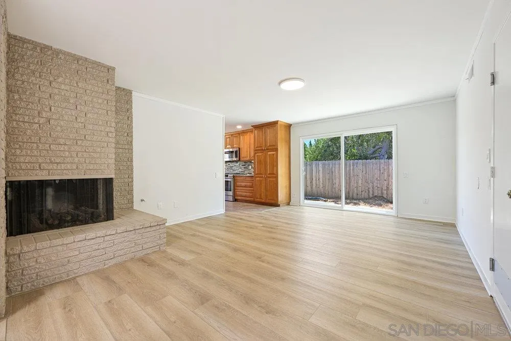 14545 Hillndale Way Poway, CA 92064 - Photo 8 of 27 a view of empty room with wooden floor and fireplace