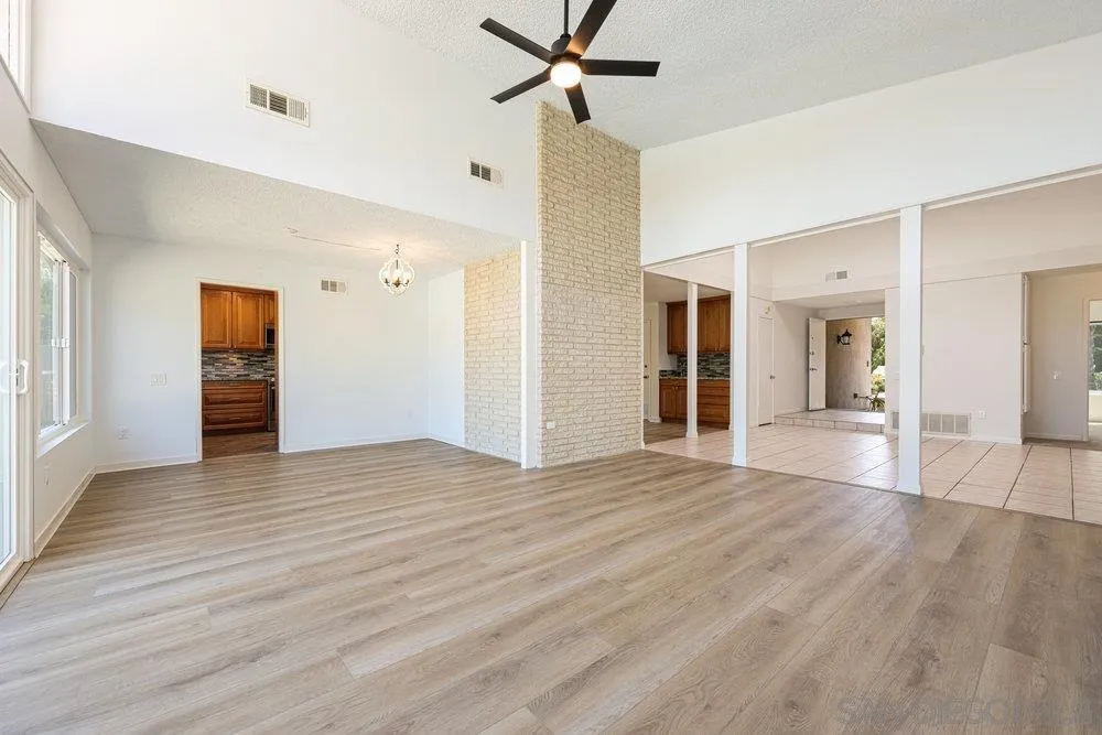 14545 Hillndale Way Poway, CA 92064 - Photo 10 of 27 a view of an empty room with wooden floor and a ceiling fan