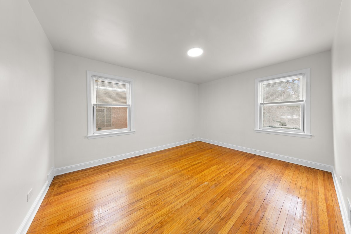 8142 South Yates Boulevard Chicago, IL 60617 - Photo 16 of 25 a view of empty room with wooden floor and fan