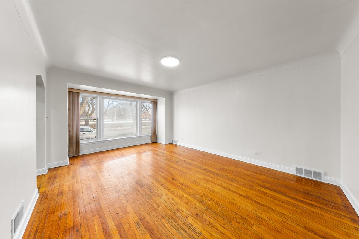 8142 South Yates Boulevard Chicago, IL 60617 - Photo 2 of 25 a view of an empty room and wooden floor