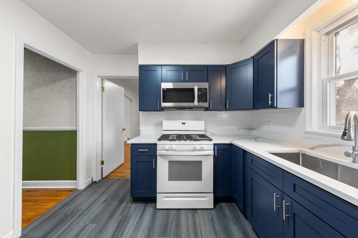 8142 South Yates Boulevard Chicago, IL 60617 - Photo 8 of 25 a kitchen with a stove and a sink