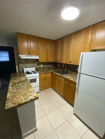 a view of a livingroom with kitchen and furniture