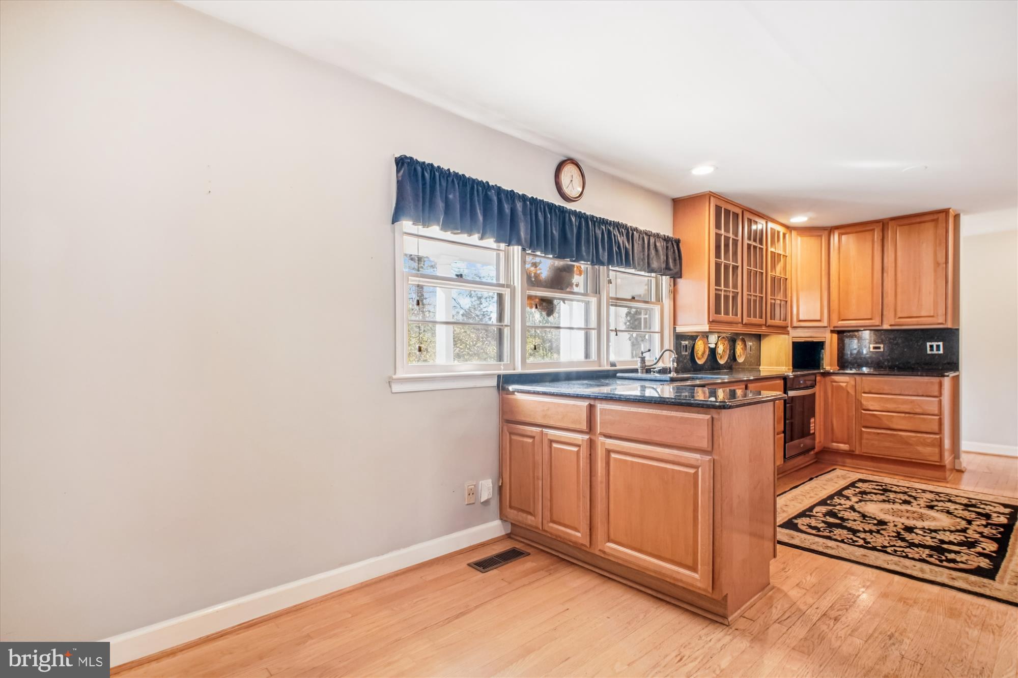 2627 Five Oaks Road Vienna, VA 22181 - Photo 23 of 111 a kitchen with stainless steel appliances granite countertop a stove a sink and a refrigerator