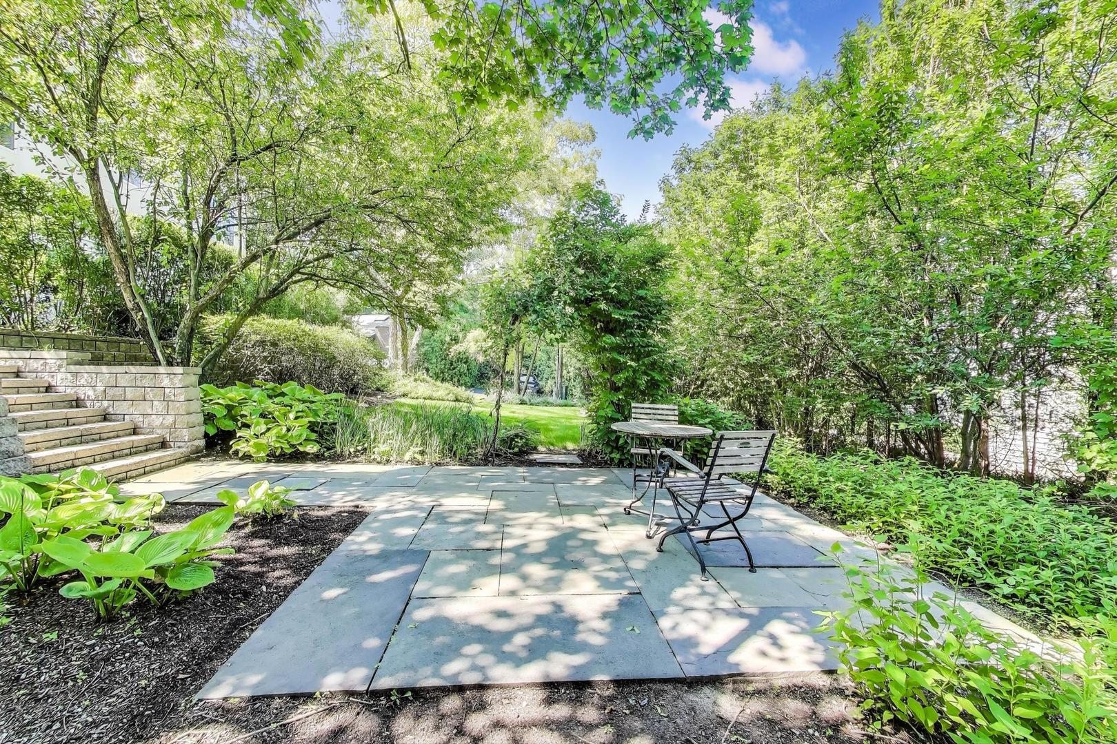 90 Riparian Road Highland Park, IL 60035 - Photo 53 of 76 a view of a patio with table and chairs and potted plants