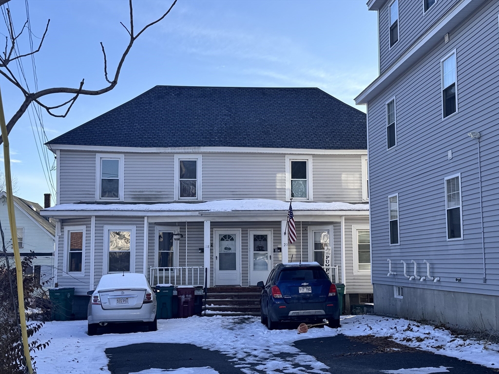 18-22 Burgess Street Lowell, MA 01851 - Photo 2 of 12 a front view of a house with parking space