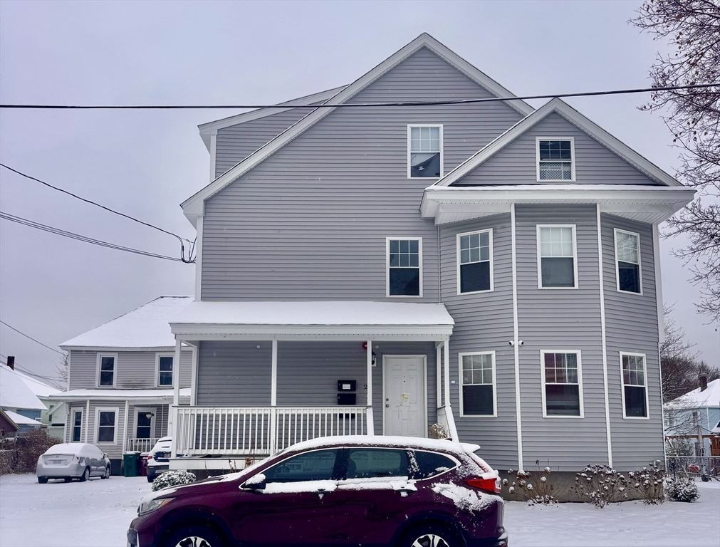 18-22 Burgess Street Lowell, MA 01851 - Photo 5 of 12 a front view of a house with parking