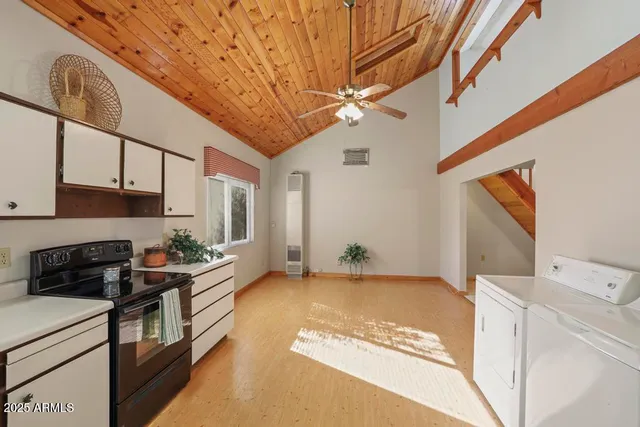 a kitchen with a stove and a white cabinets