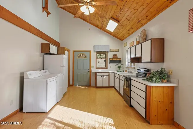 a kitchen with stainless steel appliances granite countertop a stove and cabinets